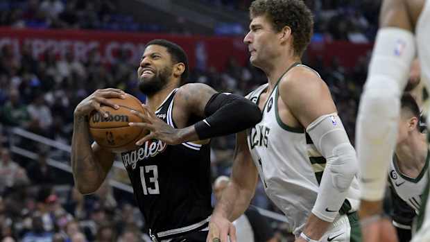 Los Angeles Clippers forward Paul George (13) drives past Milwaukee Bucks center Brook Lopez (11) i