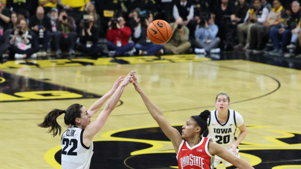 Mar 3, 2024; Iowa City, Iowa, USA; Iowa Hawkeyes guard Caitlin Clark (22) shoots over the hands of Ohio State Buckeyes guard Taylor Thierry (2) during the first half at Carver-Hawkeye Arena.