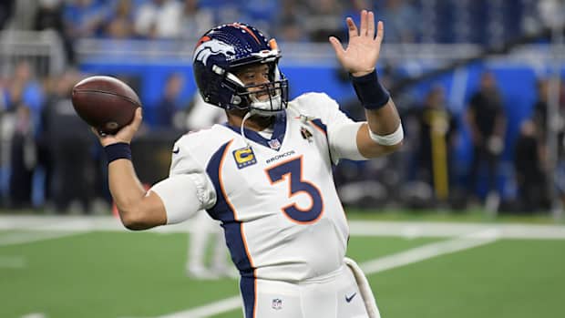 Denver Broncos quarterback Russell Wilson warms up before his team’s game in Detroit on Dec. 16, 2023.