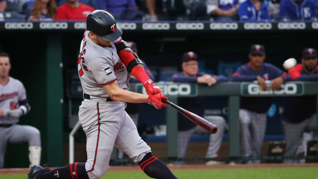 Minnesota Twins third baseman Josh Donaldson (20) hits a home run in a game against the Minnesota Twins at Kauffman Stadium in Kansas City, Mo., on Oct. 2, 2021.