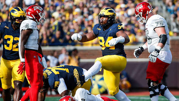 Michigan defensive lineman Kris Jenkins (94) celebrates a sack against UNLV quarterback Doug Brumfield (2) during the first half at Michigan Stadium in Ann Arbor on Saturday, Sept. 9, 2023.