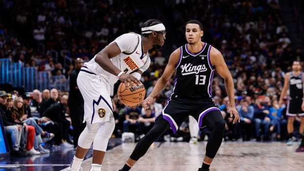 Feb 28, 2024; Denver, Colorado, USA; Denver Nuggets guard Reggie Jackson (7) controls the ball as Sacramento Kings forward Keegan Murray (13) guards in the third quarter at Ball Arena. Mandatory Credit: Isaiah J. Downing-USA TODAY Sports  