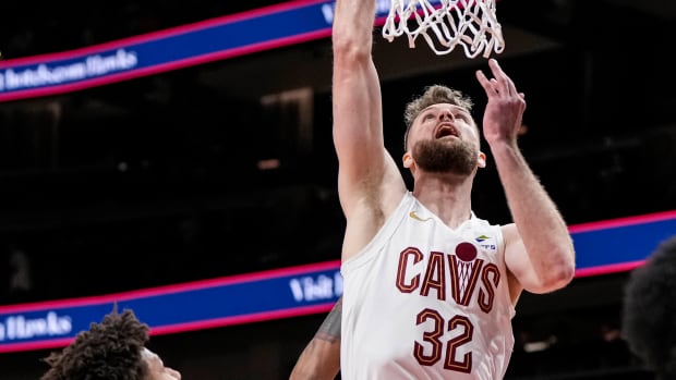 Jan 20, 2024; Atlanta, Georgia, USA; Cleveland Cavaliers forward Dean Wade (32) scores a basket over Atlanta Hawks forward Jalen Johnson (1) during the first half at State Farm Arena.