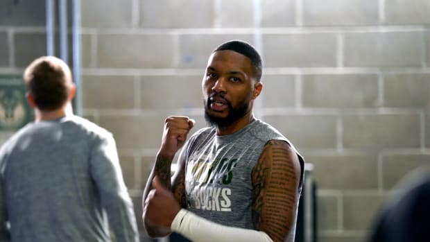 Milwaukee Bucks guard Damian Lillard (0) stands outside the locker room before the start of the game against the Golden State Warriors