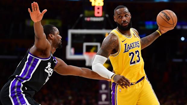 Los Angeles Lakers forward LeBron James controls the ball against Sacramento Kings forward Harrison Barnes (40) during the second half at Crypto.com Arena in Los Angeles on March 6, 2024.