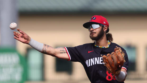 Mar 5, 2024; Jupiter, Florida, USA; Minnesota Twins second baseman Austin Martin (82) thorws to first base against the St. Louis Cardinals during the fourth inning at Roger Dean Chevrolet Stadium.