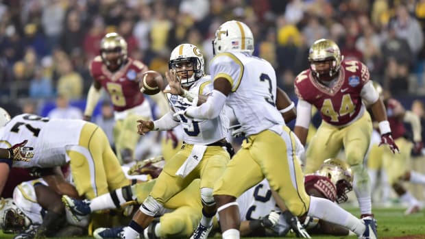 Dec 6, 2014; Charlotte, NC, USA; Georgia Tech Yellow Jackets quarterback Justin Thomas (5) pitches the ball to running back Dennis Andrews (3) in the second quarter at Bank of America Stadium. Mandatory Credit: Bob Donnan-USA TODAY Sports