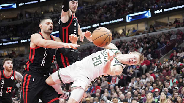 Chicago Bulls center Nikola Vucevic (9) flagrantly fouls Milwaukee Bucks guard AJ Green (20) 