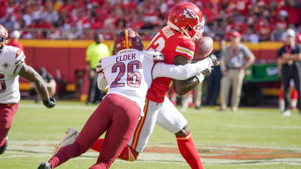 Aug 20, 2022; Kansas City, Missouri, USA; Kansas City Chiefs wide receiver Josh Gordon (12) catches a pass as Washington Commanders cornerback Corn Elder (26) defends during the second half at GEHA Field at Arrowhead Stadium. Mandatory Credit: Denny Medley-USA TODAY Sports  