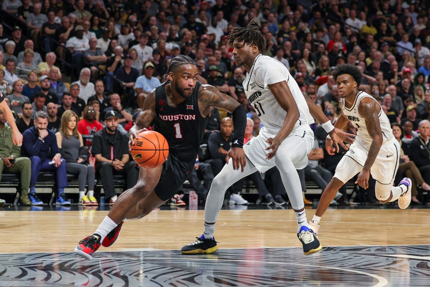 Mar 6, 2024; Orlando, Florida, USA; Houston Cougars guard Jamal Shead (1) drives around UCF Knights forward Thierno Sylla (31) during the second half at Addition Financial Arena. Mandatory Credit: Mike Watters-USA TODAY Sports  