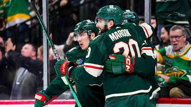 Jan 15, 2024; Saint Paul, Minnesota, USA; Minnesota Wild center Connor Dewar (26) celebrates his goal with left wing Pat Maroon (20) during the second period against the New York Islanders at Xcel Energy Center.