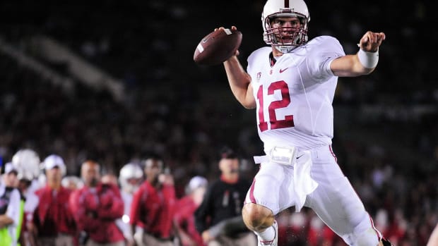 September 11, 2010; Pasadena, CA, USA; Stanford Cardinal quarterback Andrew Luck (12) leaps to throw a pass against the UCLA Bruins during the first half at the Rose Bowl. Mandatory Credit: Gary A. Vasquez-USA TODAY Sports