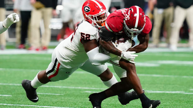 Dec 2, 2023; Atlanta, GA, USA; Georgia Bulldogs defensive lineman Christen Miller (52) tackles Alabama Crimson Tide running back Jam Miller (26) in the first quarter of the SEC Championship at Mercedes-Benz Stadium.