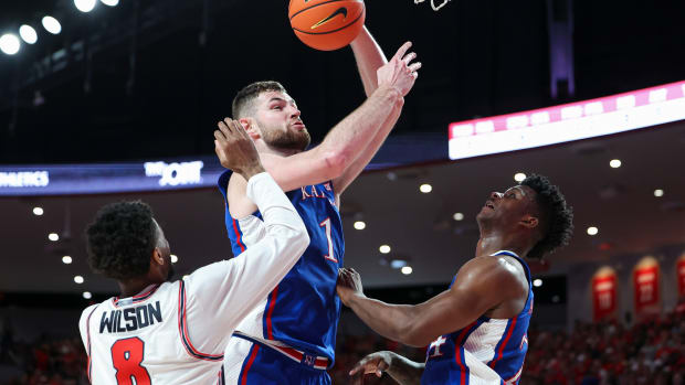 Mar 9, 2024; Houston, Texas, USA; Kansas Jayhawks center Hunter Dickinson (1) attempts to score as Houston Cougars guard Mylik Wilson (8) defends during the first half at Fertitta Center. Mandatory Credit: Troy Taormina-USA TODAY Sports  