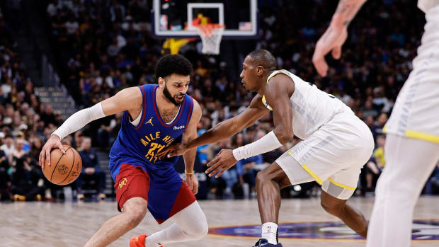 Mar 9, 2024; Denver, Colorado, USA; Denver Nuggets guard Jamal Murray (27) controls the ball against Utah Jazz guard Kris Dunn (11) in the fourth quarter at Ball Arena.