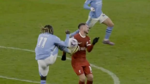 Jeremy Doku pictured (left) challenging for the ball with Alexis Mac Allister during Liverpool and Manchester City's 1-1 draw in March 2024