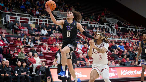 Nate Calmese drives hard to the basket at Stanford.