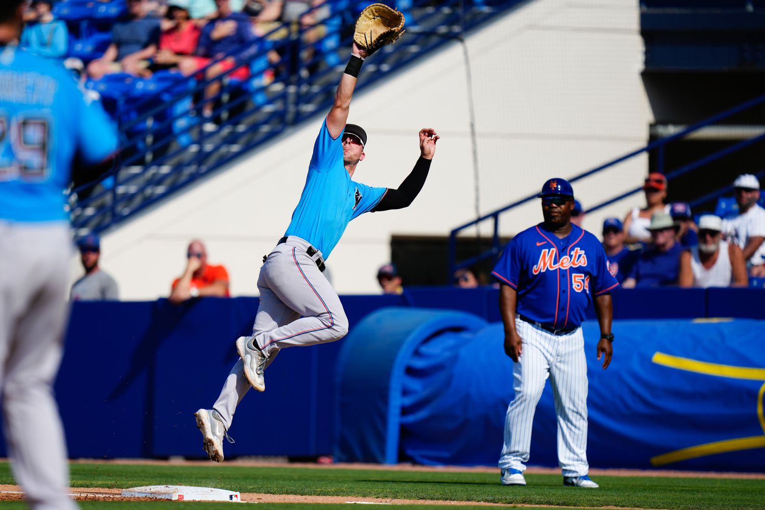 Mar 26, 2023; Port St. Lucie, Florida, USA; Miami Marlins first baseman Troy Johnston (46) attempts to make a catch against the New York Mets during the second inning at Clover Park.