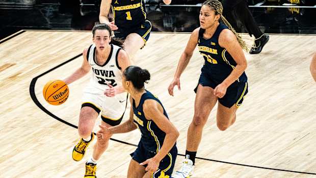 Michigan guard Laila Phelia (5) drives to the basket against Iowa guard Caitlin Clark (22) during the Big Ten Tournament semifinals at the Target Center on Saturday, March 9, 2024, in Minneapolis, Minn.