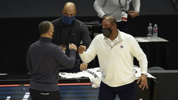Philadelphia 76ers head coach Doc Rivers (right) meets with LA Clippers head coach Tyronn Lue