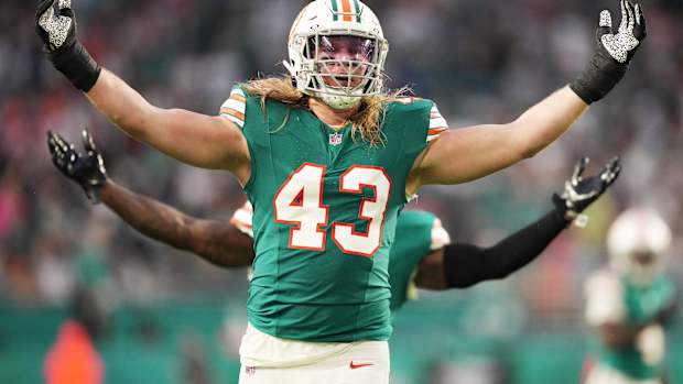 Miami Dolphins linebacker Andrew Van Ginkel (43) and linebacker David Long Jr., rear, celebrate a sack against the Dallas Cowboys during the first half of an NFL game at Hard Rock Stadium in Miami Gardens, Dec. 24, 2023.