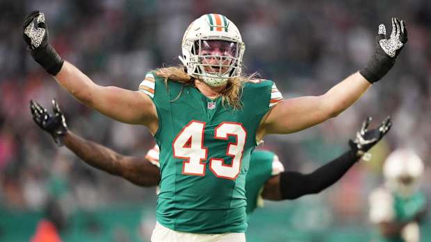 Miami Dolphins linebacker Andrew Van Ginkel (43) and linebacker David Long Jr., rear, celebrate a sack against the Dallas Cowboys during the first half of an NFL game at Hard Rock Stadium in Miami Gardens, Dec. 24, 2023.