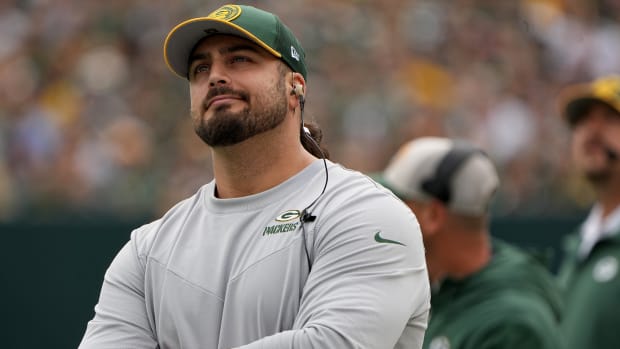 Green Bay Packers offensive tackle David Bakhtiari watches his team during the first quarter of their game against the New Orleans Saints at Lambeau Field