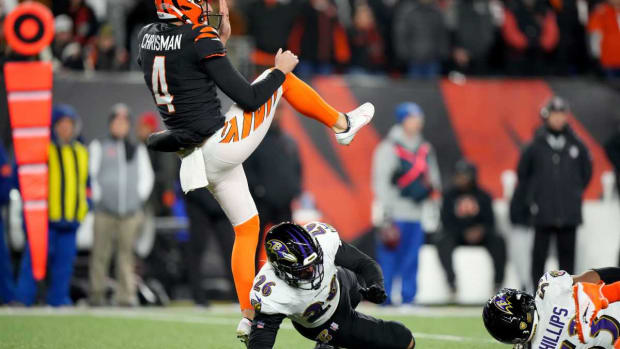 Cincinnati Bengals punter Drue Chrisman (4) draws a from Baltimore Ravens safety Geno Stone (26) in the fourth quarter during an NFL wild-card playoff football game between the Baltimore Ravens and the Cincinnati Bengals, Sunday, Jan. 15, 2023, at Paycor Stadium in Cincinnati. The Cincinnati Bengals won, 24-17. The Cincinnati Bengals advance with the win to play the Buffalo Bills in the divisional round. Baltimore Ravens At Cincinnati Bengals Afc Wild Card Jan 15 0466