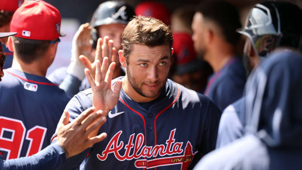 Mar 10, 2024; Tampa, Florida, USA; Atlanta Braves infielder David Fletcher (64) is congratulated in the dugout after he scored against the New York Yankees during the first inning at George M. Steinbrenner Field.