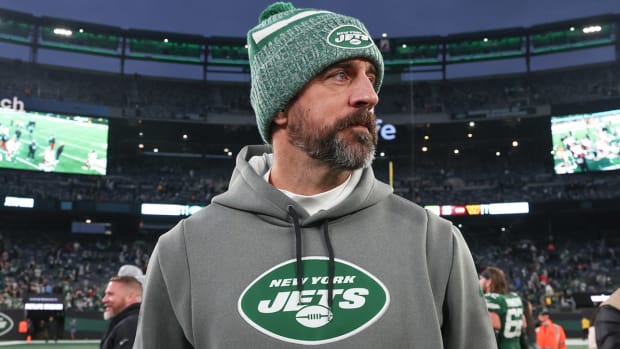 Aaron Rodgers walks off the field after a game.