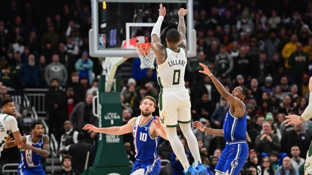Jan 14, 2024; Milwaukee, Wisconsin, USA; Milwaukee Bucks guard Damian Lillard (0) scores the game-winning three-point basket at the end of overtime against the Sacramento Kings at Fiserv Forum. Mandatory Credit: Benny Sieu-USA TODAY Sports