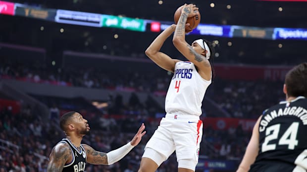 Mar 10, 2024; Los Angeles, California, USA; Los Angeles Clippers guard Brandon Boston Jr. (4) shoots the ball over Milwaukee Bucks guard Damian Lillard (0) during the first quarter at Crypto.com Arena. Mandatory Credit: Kiyoshi Mio-USA TODAY Sports