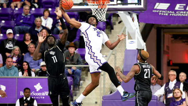 Mar 9, 2024; Fort Worth, Texas, USA; TCU Horned Frogs forward Emanuel Miller (2) catches the ball in front of UCF Knights forward Ibrahima Diallo (11) during the second half at Ed and Rae Schollmaier Arena.