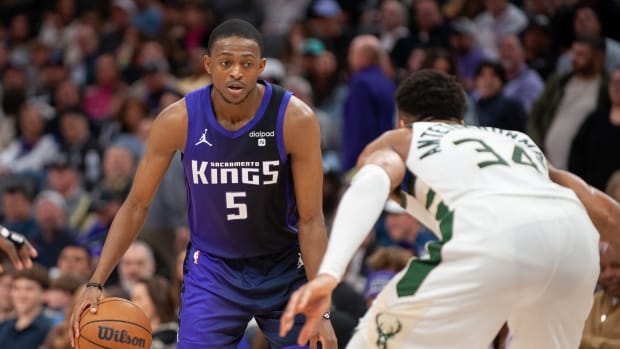 Mar 12, 2024; Sacramento, California, USA; Sacramento Kings guard De'Aaron Fox (5) controls the ball against Milwaukee Bucks forward Giannis Antetokounmpo (34) during the fourth quarter at Golden 1 Center. Mandatory Credit: Ed Szczepanski-USA TODAY Sports  