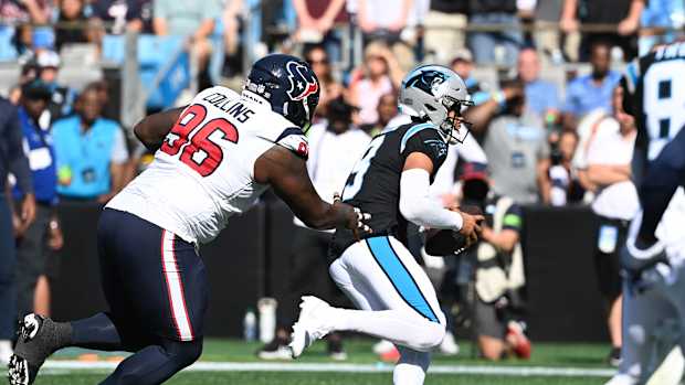 Oct 29, 2023; Charlotte, North Carolina, USA; Carolina Panthers quarterback Bryce Young (9) runs as Houston Texans defensive tackle Maliek Collins (96) defends in the second quarter at Bank of America Stadium. Mandatory Credit: Bob Donnan-USA TODAY Sports  