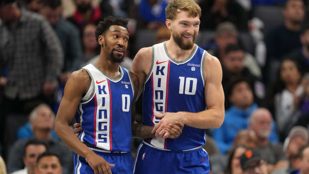 Dec 4, 2023; Sacramento, California, USA; Sacramento Kings guard Malik Monk (0) talks with forward Domantas Sabonis (10) during the second quarter against the New Orleans Pelicans at Golden 1 Center. Mandatory Credit: Darren Yamashita-USA TODAY Sports  