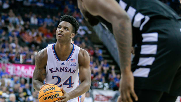Mar 13, 2024; Kansas City, MO, USA; Kansas Jayhawks forward K.J. Adams Jr. (24) shoots a free throw during the first half against the Cincinnati Bearcats at T-Mobile Center.
