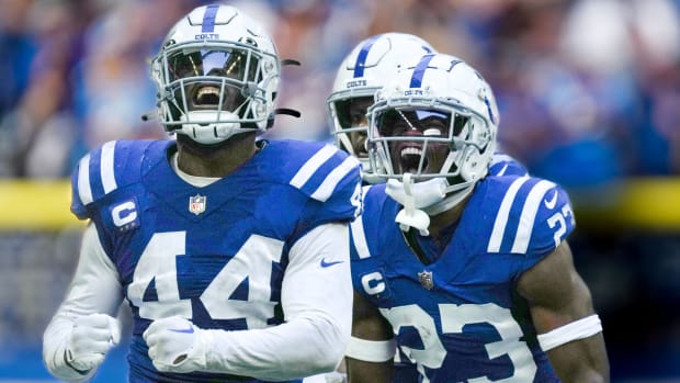 Oct 2, 2022; Indianapolis, Indiana, USA; Indianapolis Colts linebacker Zaire Franklin (44) and cornerback Kenny Moore II (23) celebrate after a tackle on Tennessee Titans quarterback Ryan Tannehill (not pictured) at Lucas Oil Stadium.