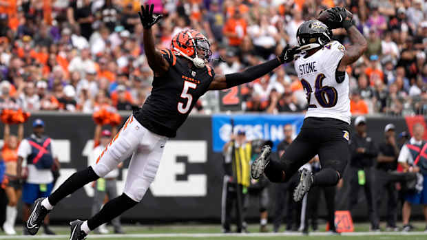 Baltimore Ravens safety Geno Stone (26) intercepts a pass intended for Cincinnati Bengals wide receiver Tee Higgins (5) in the third quarter of a Week 2 NFL football game between the Baltimore Ravens and the Cincinnati Bengals Sunday, Sept. 17, 2023, at Paycor Stadium in Cincinnati.