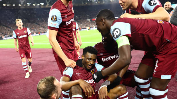 Mohammed Kudus pictured (center) sitting on a plastic stool while being mobbed by his teammates after scoring an amazing solo goal for West Ham United in a 5-0 win over Freiburg in the UEFA Europa League in March 2024