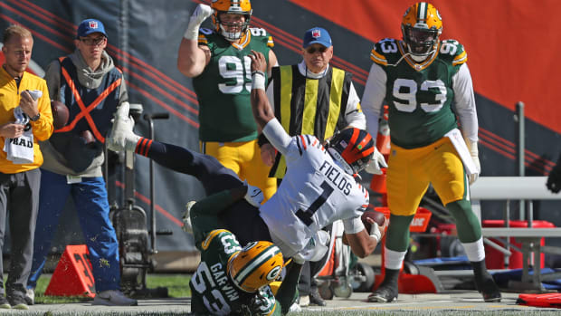 Oct 17, 2021; Chicago, Illinois, USA; Chicago Bears quarterback Justin Fields (1) is tackled by Green Bay Packers linebacker Jonathan Garvin (53) during the first half at Soldier Field. Mandatory Credit: Dennis Wierzbicki-USA TODAY Sports  