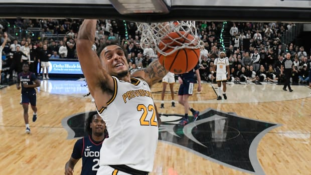 Providence Friars guard Devin Carter (22) dunks the ball against the Connecticut Huskies during the first half at Amica Mutual Pavilion. 