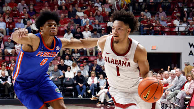 Feb 21, 2024; Tuscaloosa, Alabama, USA; Alabama Crimson Tide guard Mark Sears (1) drives the baseline around Florida Gators guard Zyon Pullin (0) during the first half at Coleman Coliseum. Mandatory Credit: Butch Dill-USA TODAY Sports