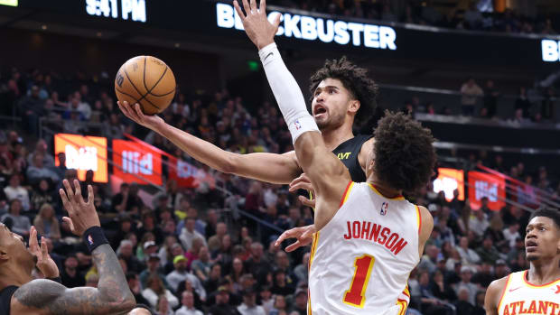 Mar 15, 2024; Salt Lake City, Utah, USA; Utah Jazz guard Johnny Juzang (33) goes to the basket against Atlanta Hawks forward Jalen Johnson (1) during the third quarter at Delta Center.