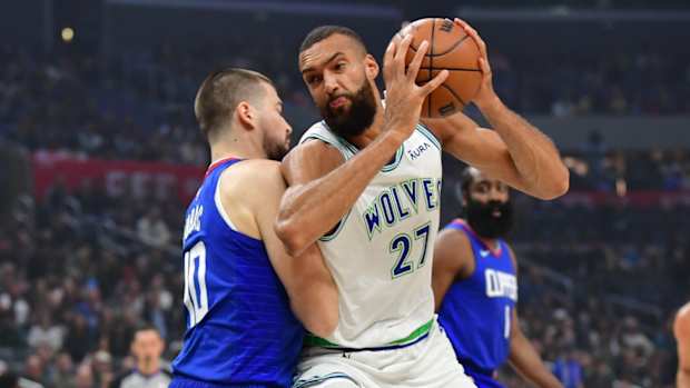 Mar 12, 2024; Los Angeles, California, USA; Minnesota Timberwolves center Rudy Gobert (27) moves to the basket against Los Angeles Clippers center Ivica Zubac (40) during the first half at Crypto.com Arena.