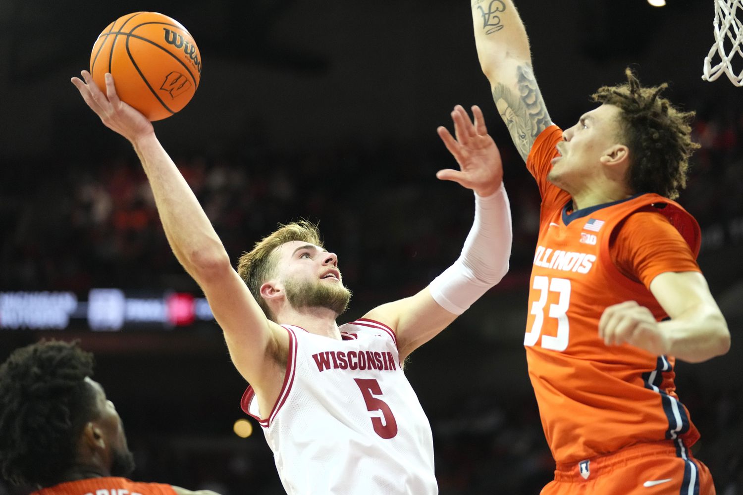 Wisconsin Badgers forward Tyler Wahl (5) scores against Illinois Fighting Illini forward Coleman Hawkins (33) during the second half at the Kohl Center.