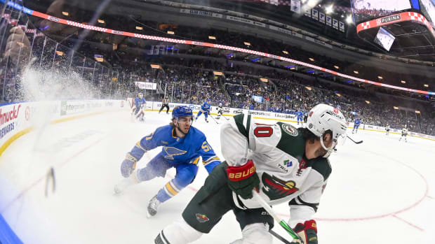 Mar 16, 2024; St. Louis, Missouri, USA; Minnesota Wild center Marcus Johansson (90) controls the puck as St. Louis Blues defenseman Matthew Kessel (51) defends during the first period at Enterprise Center.