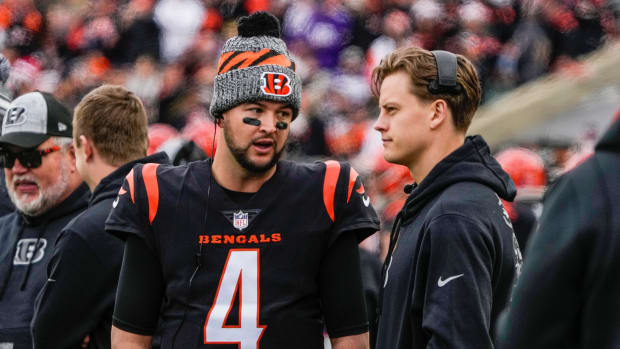 Cincinnati Bengals quarterbacks AJ McCarron (4) and Joe Burrow (9) talk as the Bengals take on Minnesota Vikings at Paycor Stadium Saturday, December 16, 2023.