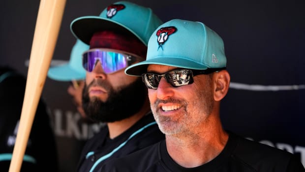Diamondbacks manager Torey Lovullo watches his team play the Padres in Peoria. Also pictured, infielder Emmanuel Rivera.