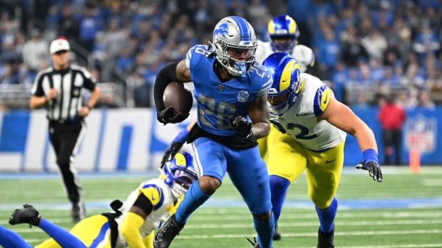 Jan 14, 2024; Detroit, Michigan, USA; Detroit Lions running back Jahmyr Gibbs (26) runs against Los Angeles Rams defensive end Jonah Williams (92) during the first half of a 2024 NFC wild card game at Ford Field.
